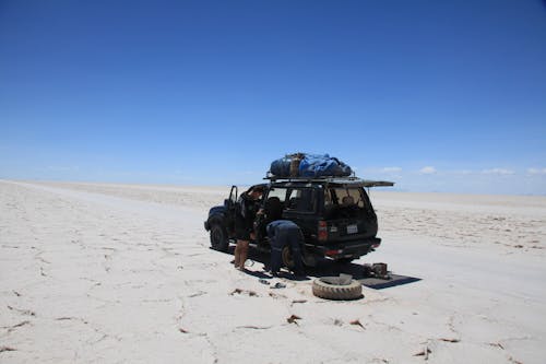 Black SUV on a Desert Under Blue Sky