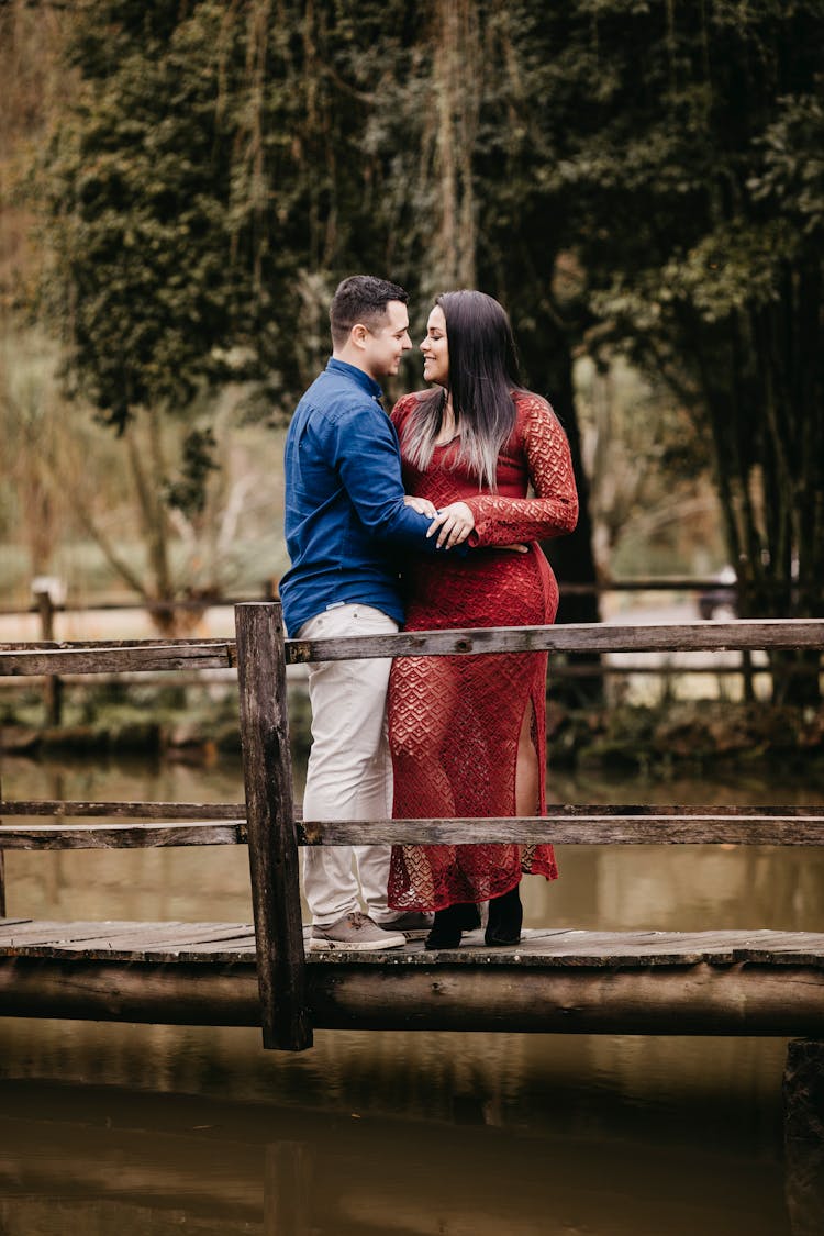 Diverse Couple Embracing On Old Wooden Bridge