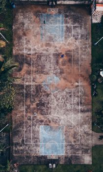 Aerial shot of an old basketball court surrounded by greenery in Manila, Philippines.