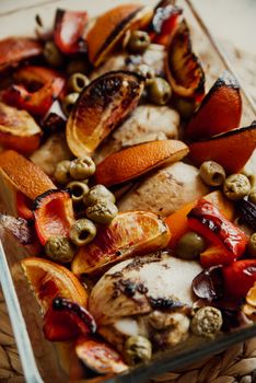 Delicious baked chicken with caramelized oranges, olives, and red peppers.