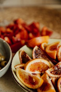 Close-up of freshly sliced blood oranges in a bowl, emphasizing natural freshness.