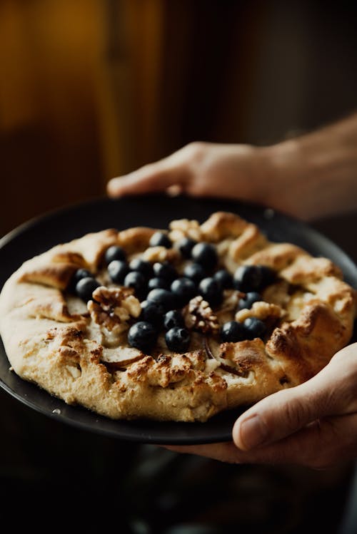 Close-Up Shot of a Person Holding a Pie