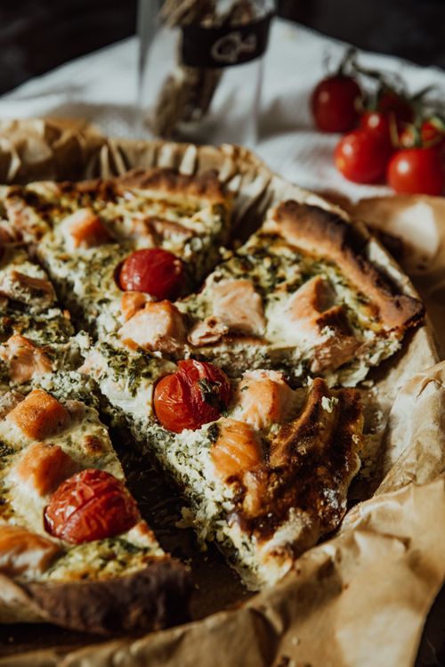Free Mouthwatering quiche with cheese, salmon, and cherry tomatoes; perfect for healthy eating. Stock Photo