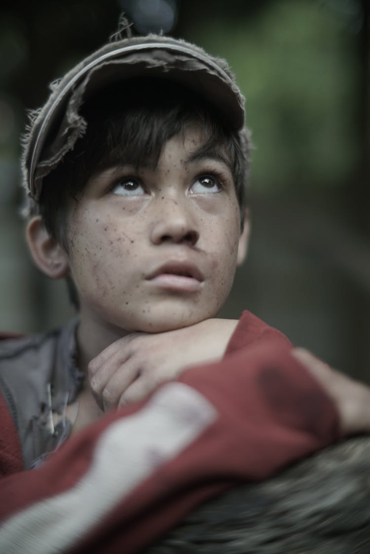 Contemplative Ethnic Child With Freckles On Street