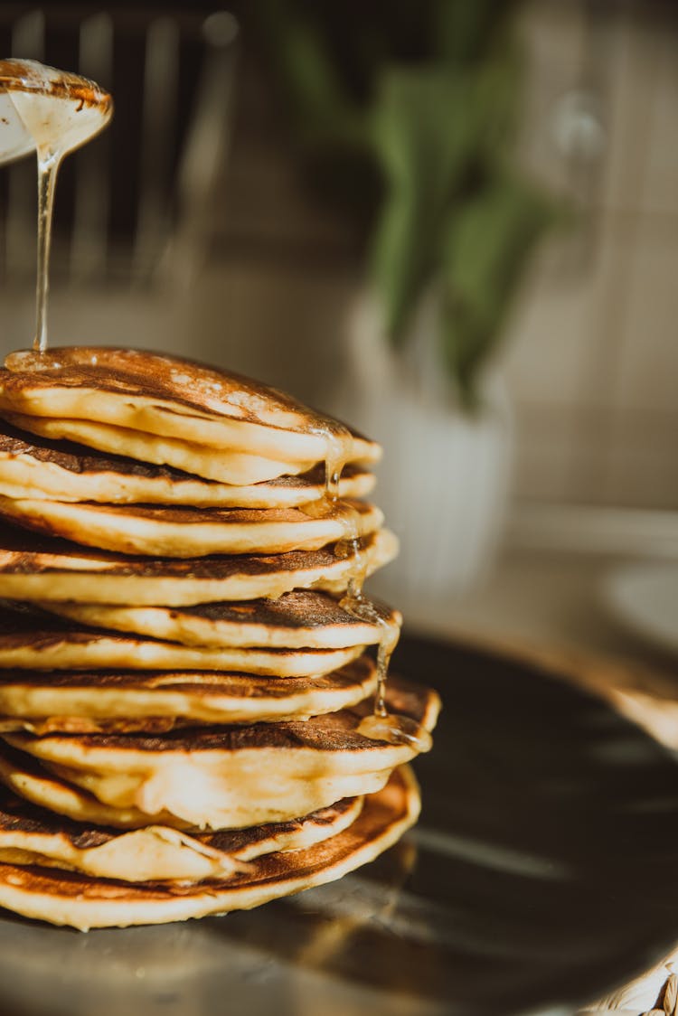 Syrup Pouring On Top Of Stack Pancakes 