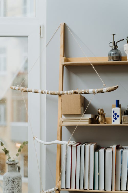 Wooden Decoration with String Hanging on Bookshelf