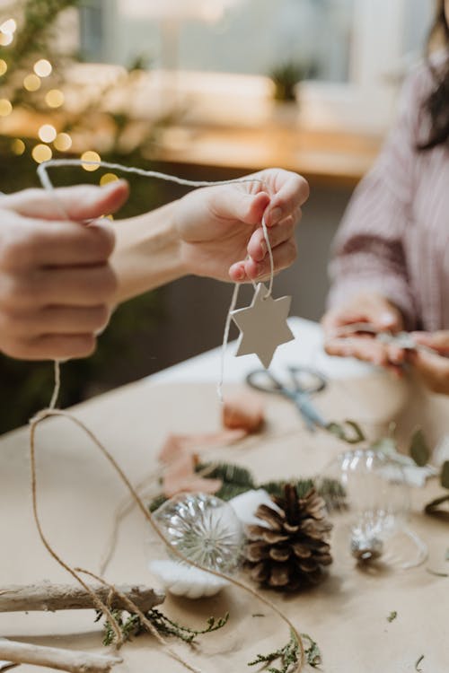 Person Holding Star with Thread