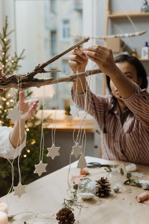 Free Crafting star-shaped Christmas decorations using natural materials indoors. Stock Photo