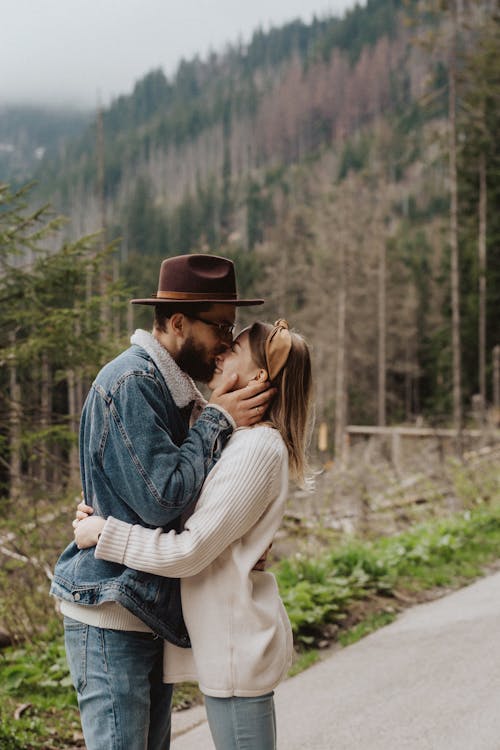 Man Wearing Blue Jean Jacket Kissing Woman on the Nose 