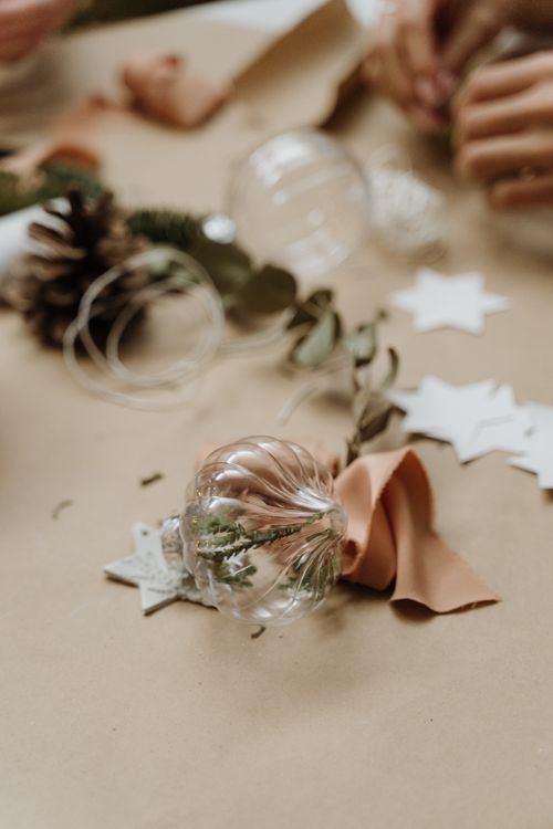 Free Festive table setup with glass baubles, pinecones, and star cutouts for Christmas decorating. Stock Photo