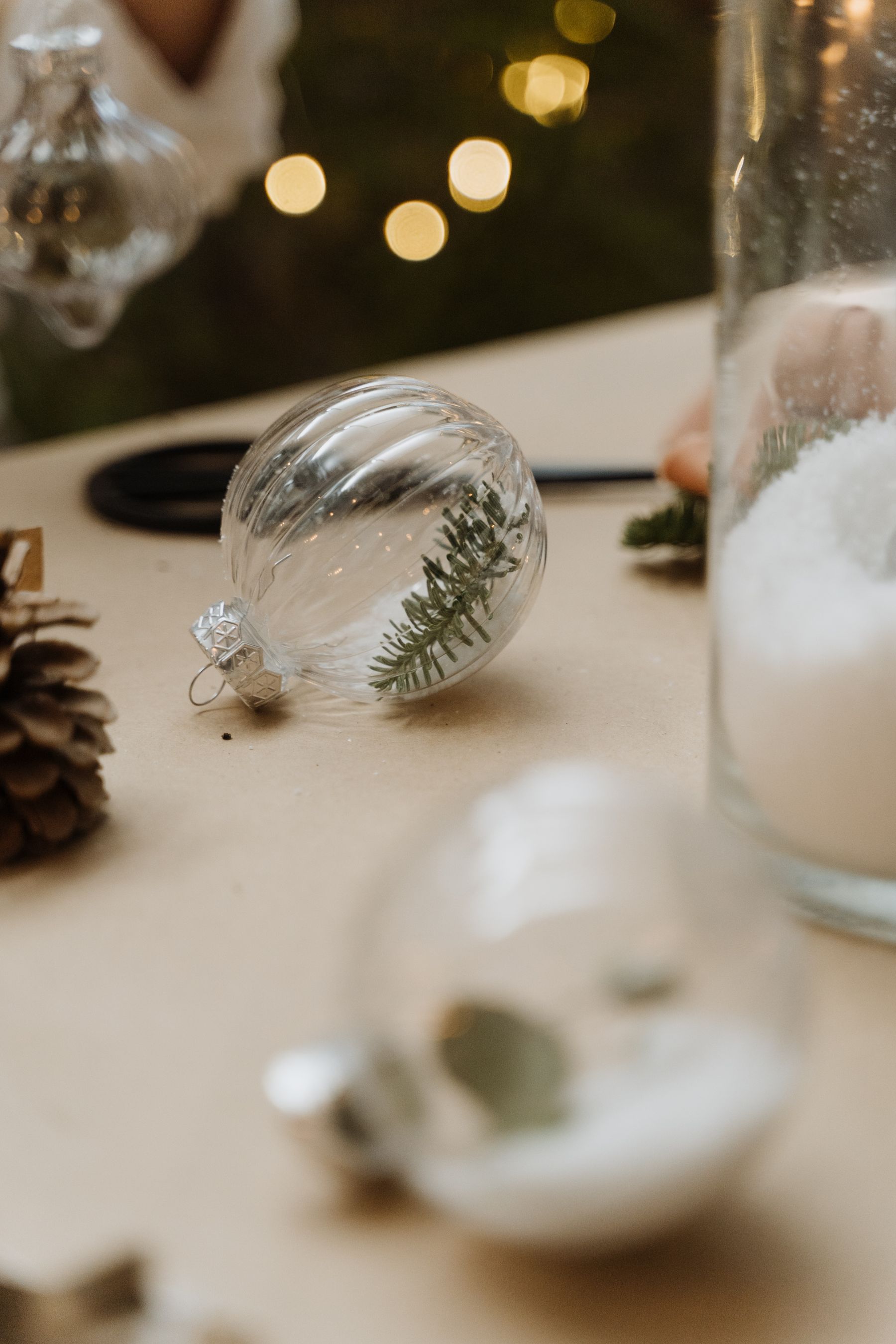 Close view of a delicate glass Christmas ornament and its hanging cap