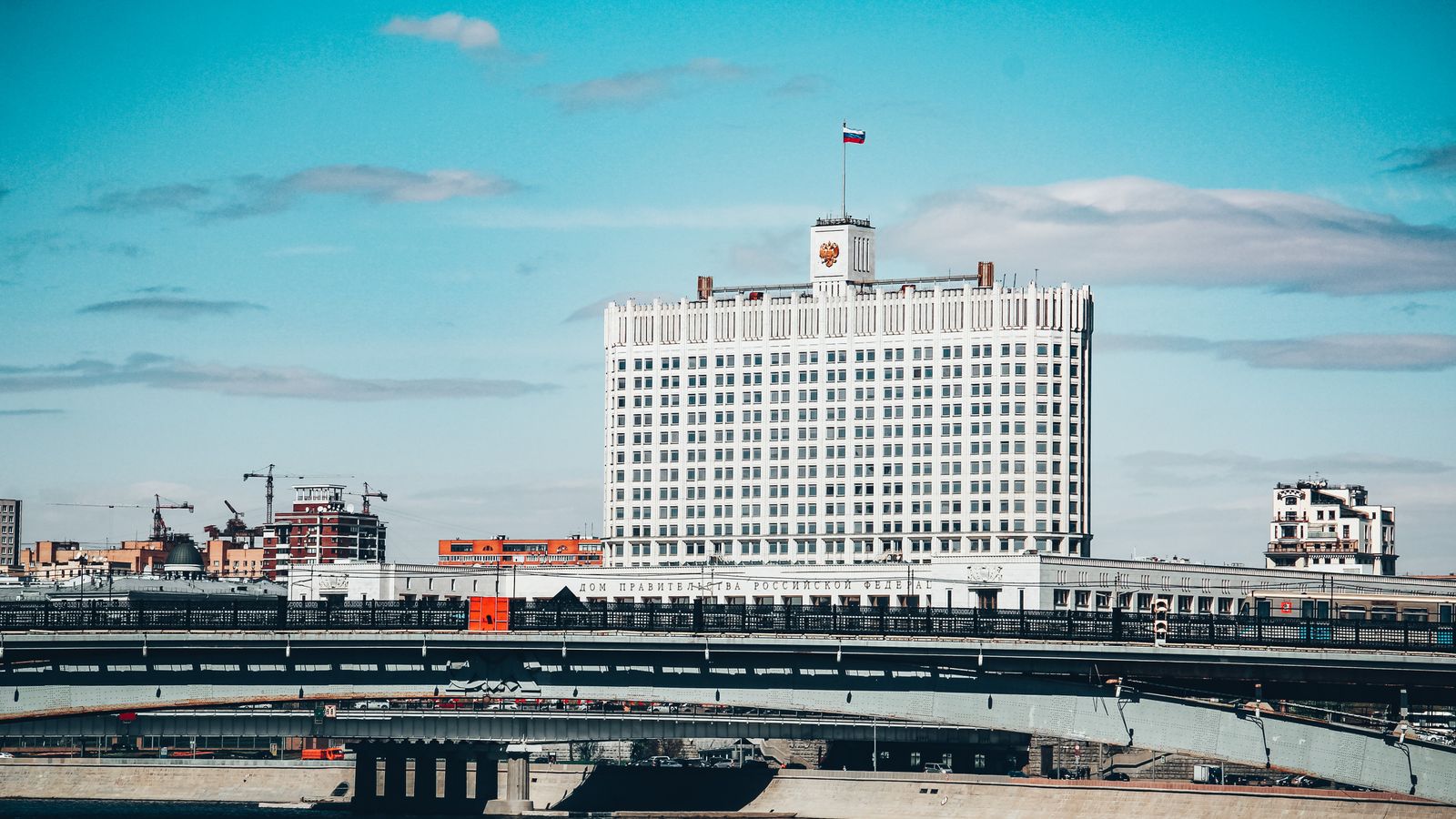 View of the Russian government building and bridge on a clear day in Moscow.