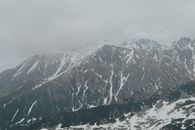 Snow Covered Mountain Under Cloudy Sky