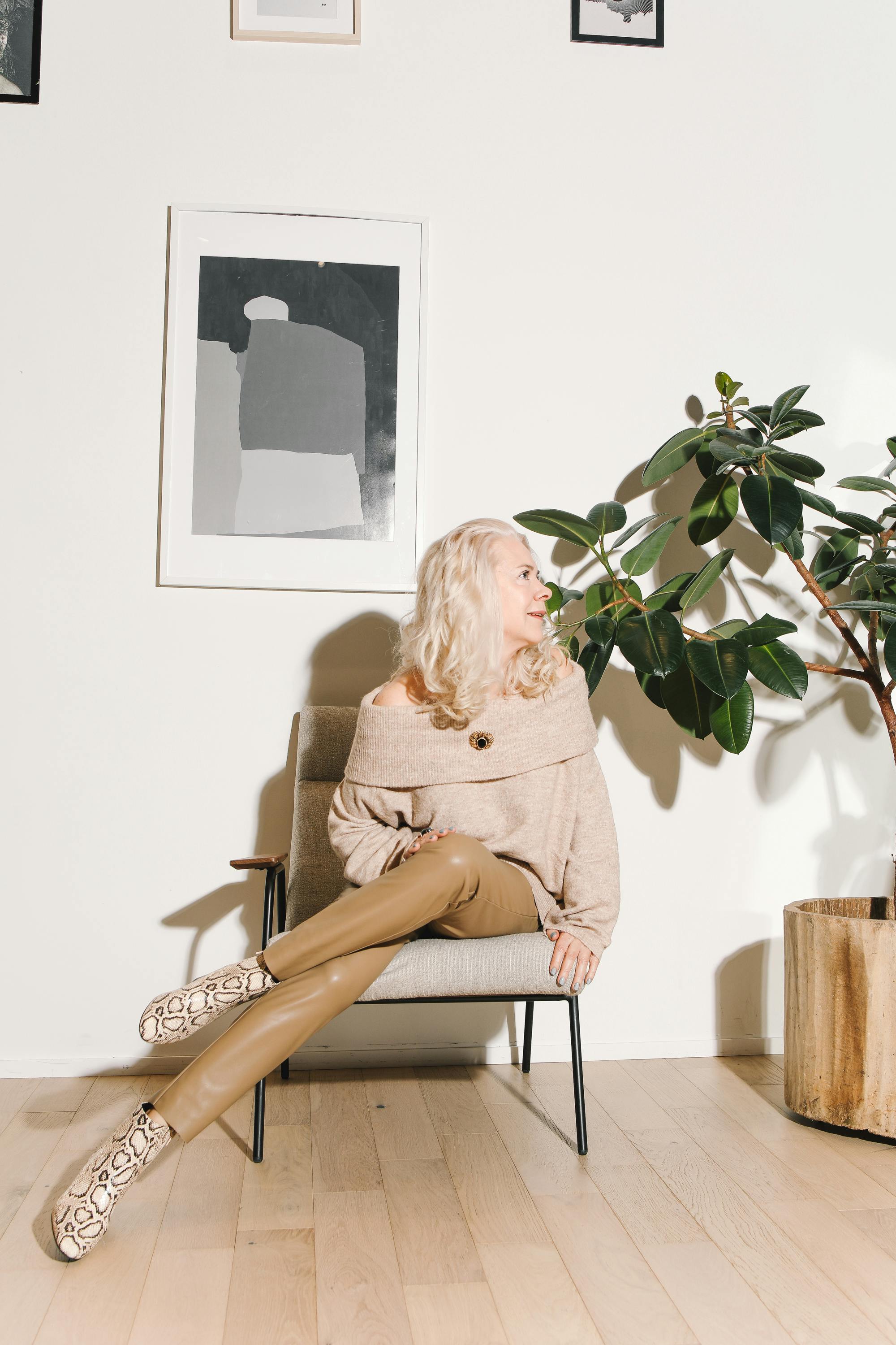 a stylish woman sitting on an armchair