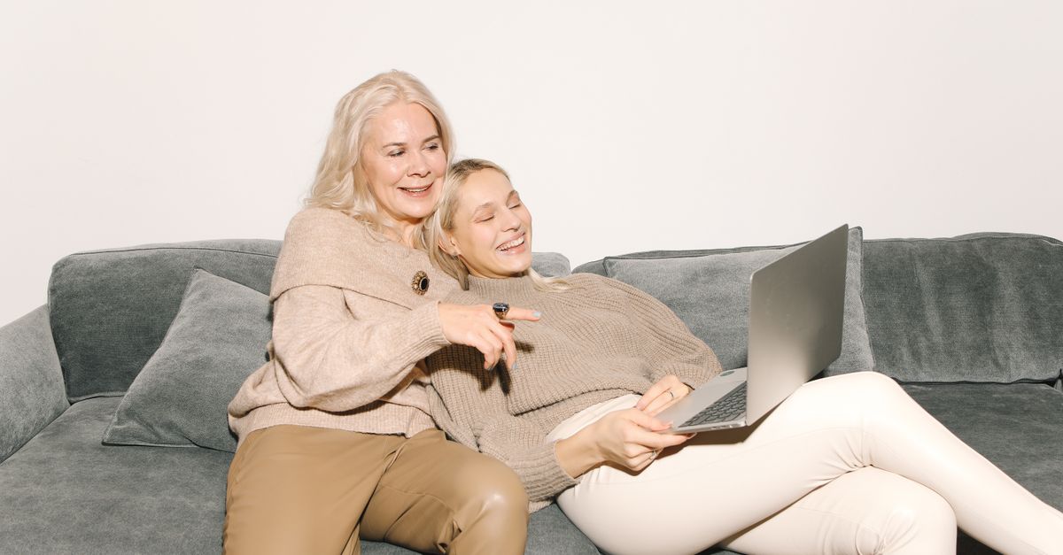 A Toronto family reviewing a shortlist of licensed retirement homes on a laptop at home