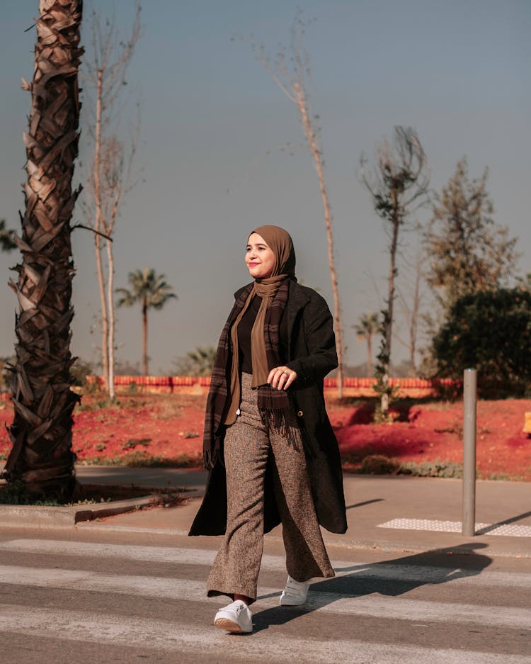 Woman Walking On A Pedestrian Lane 