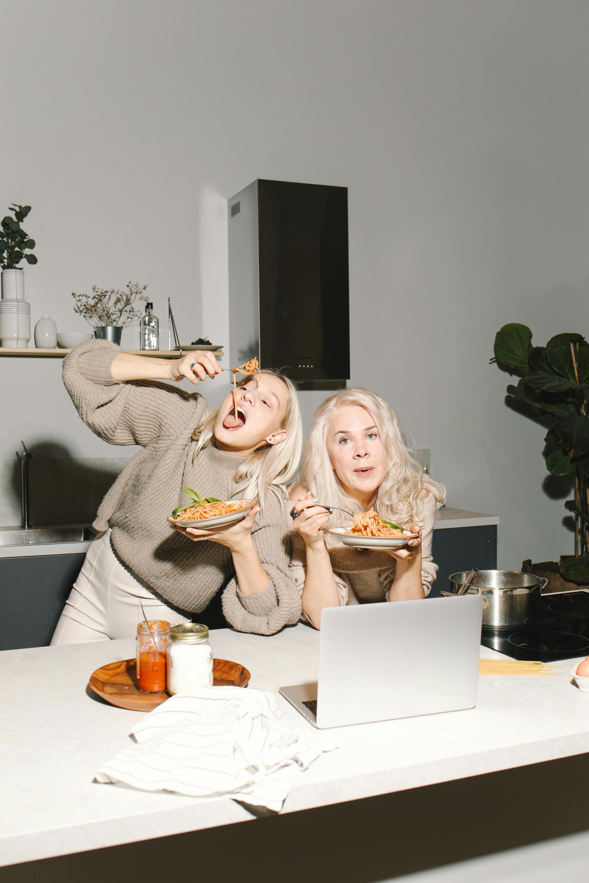 mother and daughter eating spaghetti