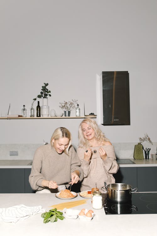 Mother And Daughter Eating Spaghetti