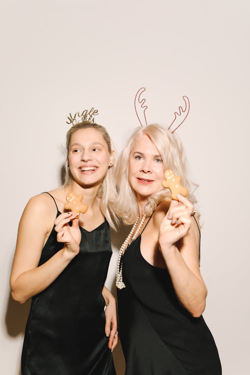 Mother And Daughter Holding Gingerbread Cookies