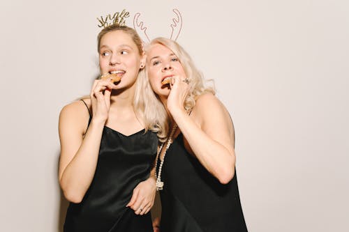 Mother And Daughter Eating Cookies