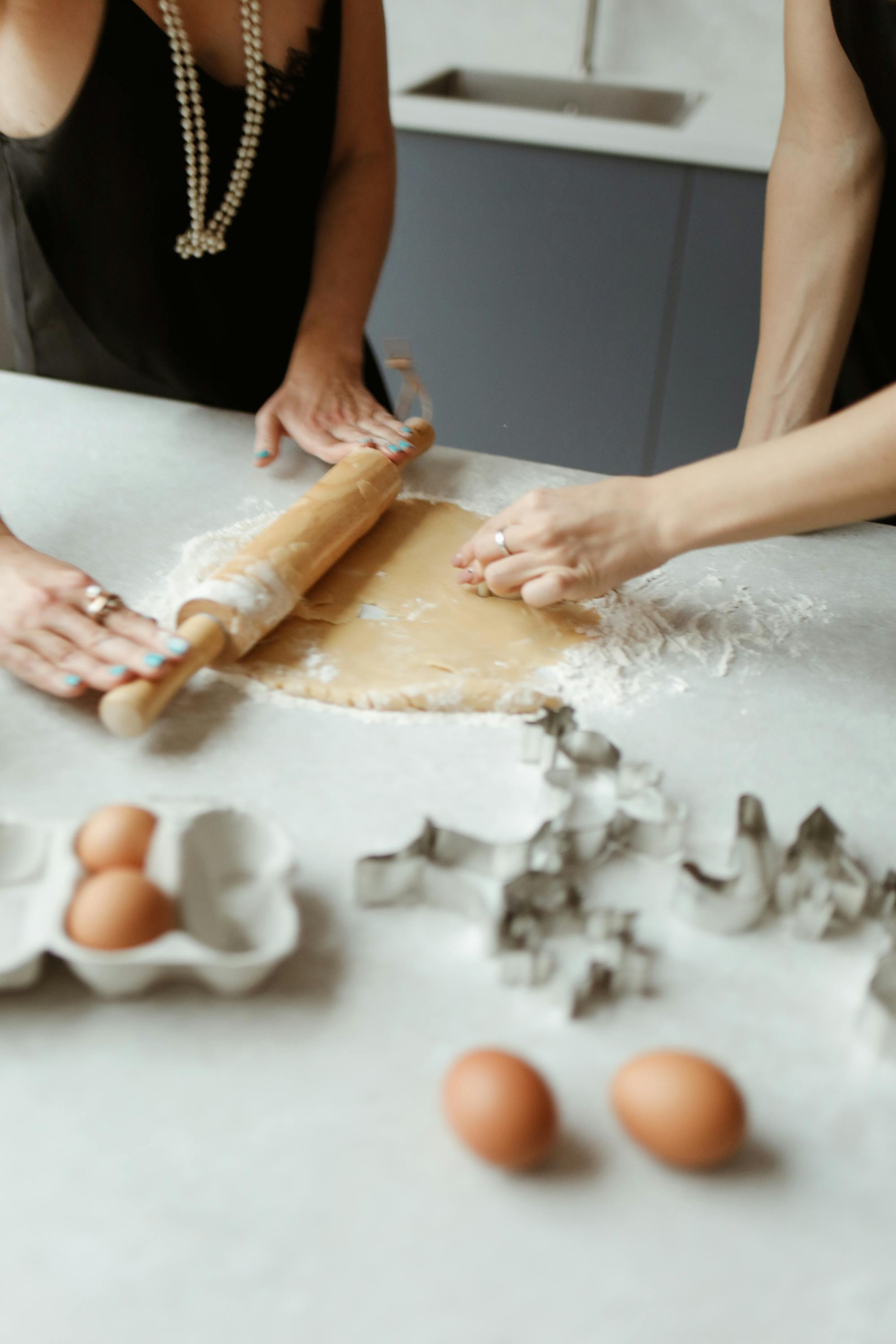 two women preparing dough for cookies