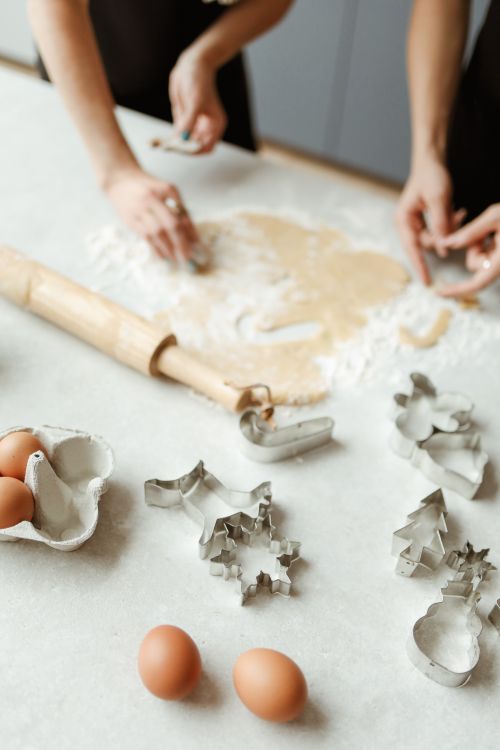 Free A bonding moment featuring home cookie baking with family hands and utensils. Stock Photo