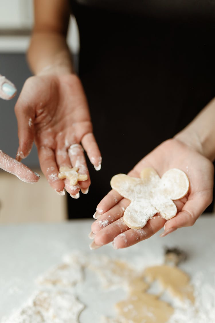 Person Making A Gingerbread Cookie