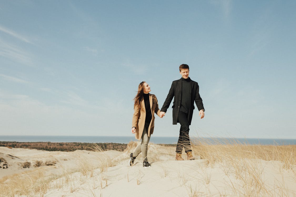 A Romantic Couple Walking on the Sand