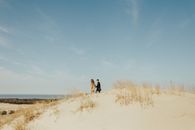2 Person Walking on White Sand