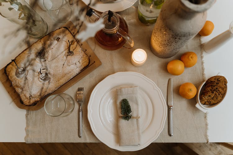 White Ceramic Plate With Stainless Steel Fork And Knife On Table