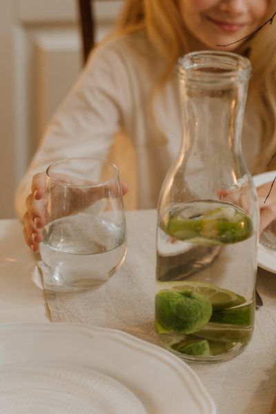 Glass of refreshing lime-infused water on a wooden table