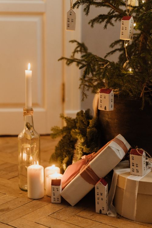 Free Warm Christmas scene with decorations, candles, and gifts under the tree. Stock Photo