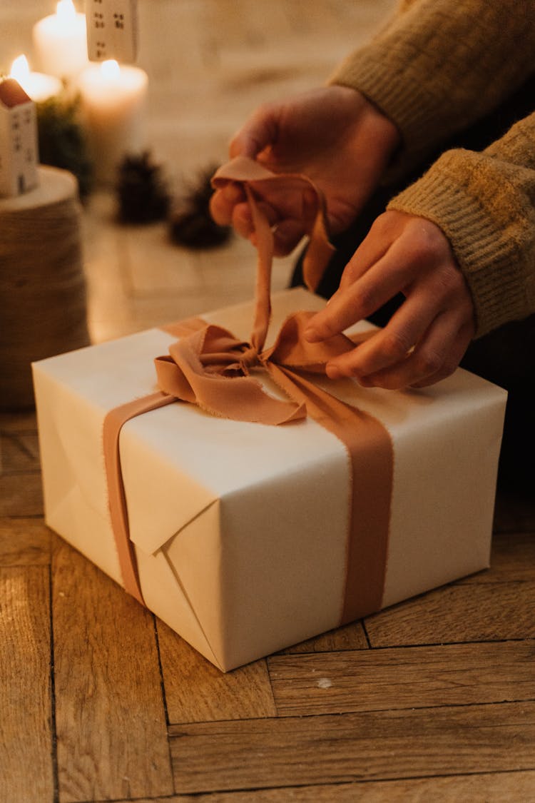 A Person Opening A Present 