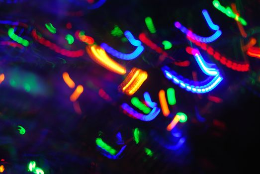 Colorful abstract bokeh pattern of neon lights creating a vibrant and dynamic composition.