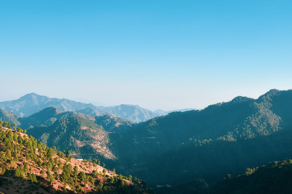 Beautiful mountain range under a bright blue sky, showcasing nature's tranquility.