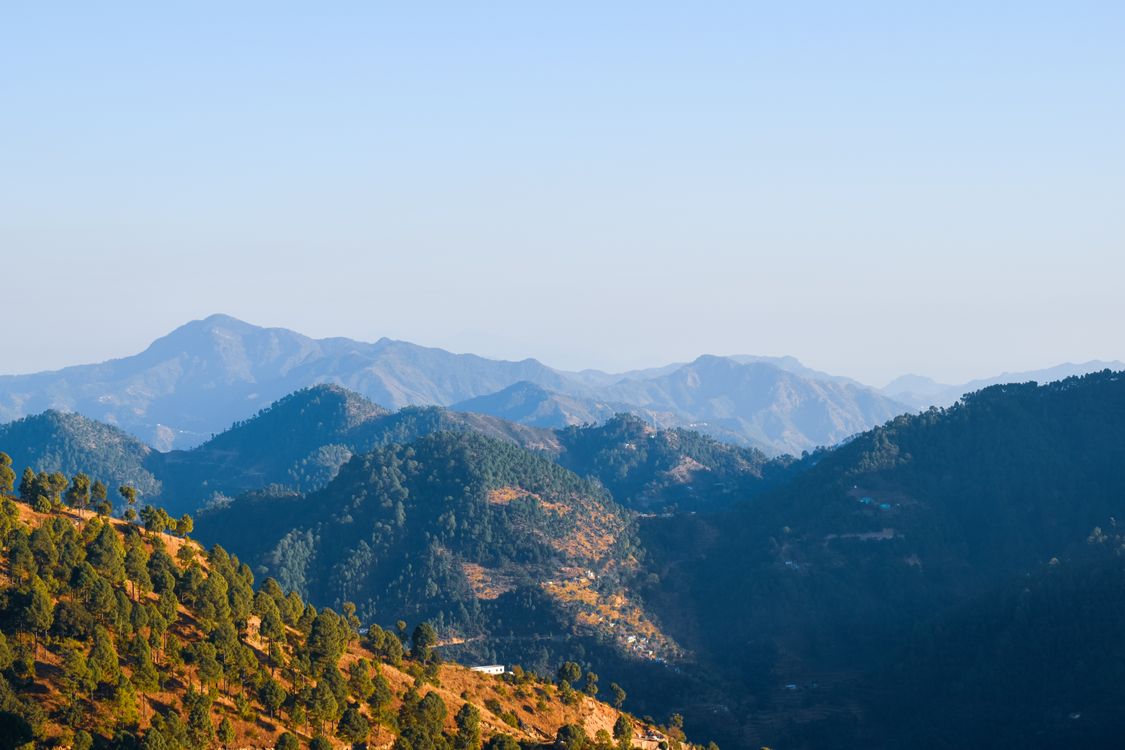 An Aerial Shot of Mountains Under the Blue Sky · Free Stock Photo