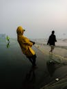 A Man Pulling a Fishing Net on the Sea