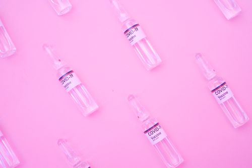 Free Top view set of small glass bottles of coronavirus vaccine arranged on pink background Stock Photo