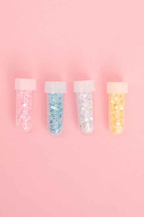 Free Top view of collection of various bright glitters in small tubes on pink background Stock Photo