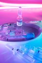 Ampoules with COVID 19 vaccine on metal tray