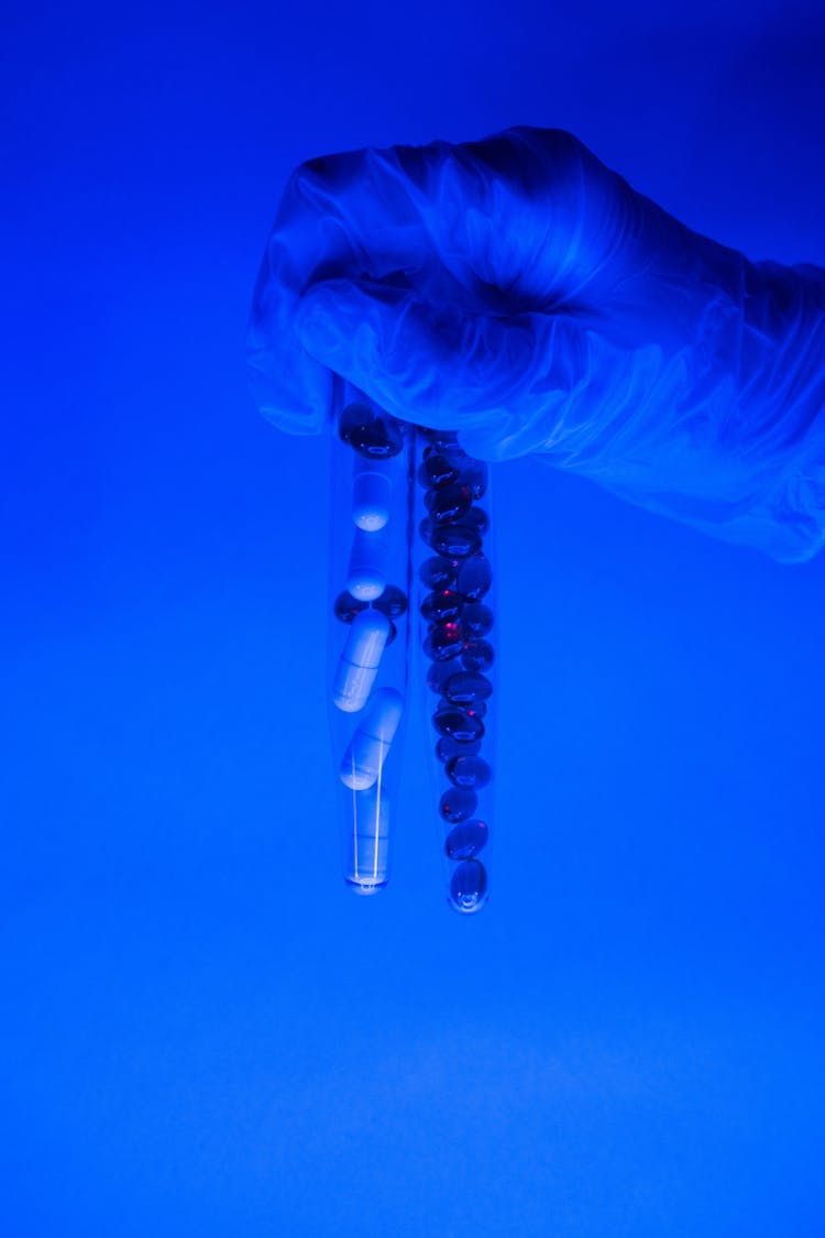 Tubes With Pills And Capsules In Hand