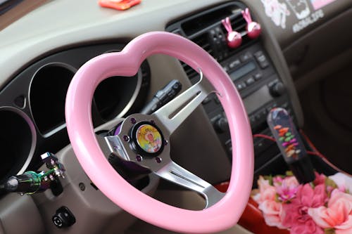 A Close-Up Shot of a Pink Steering Wheel