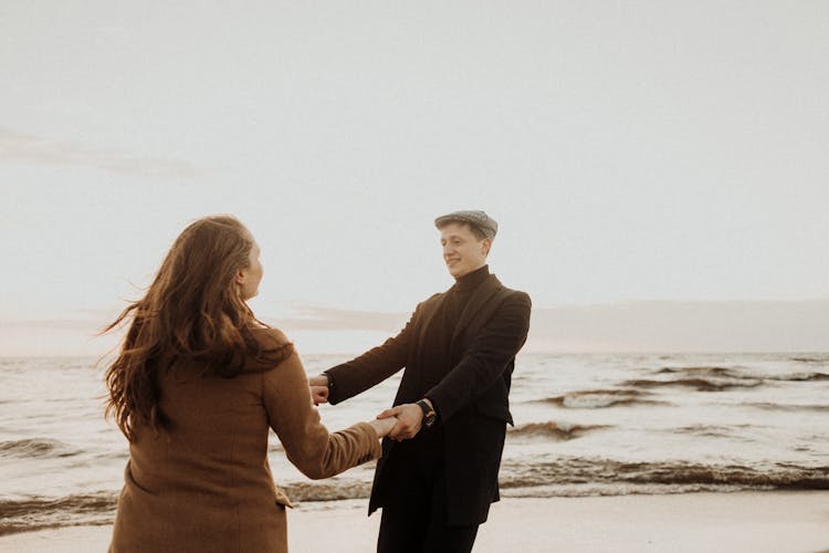 A Couple Dancing On The Beach