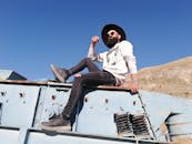 A Bearded Man Wearing a Hat and a White Sweater