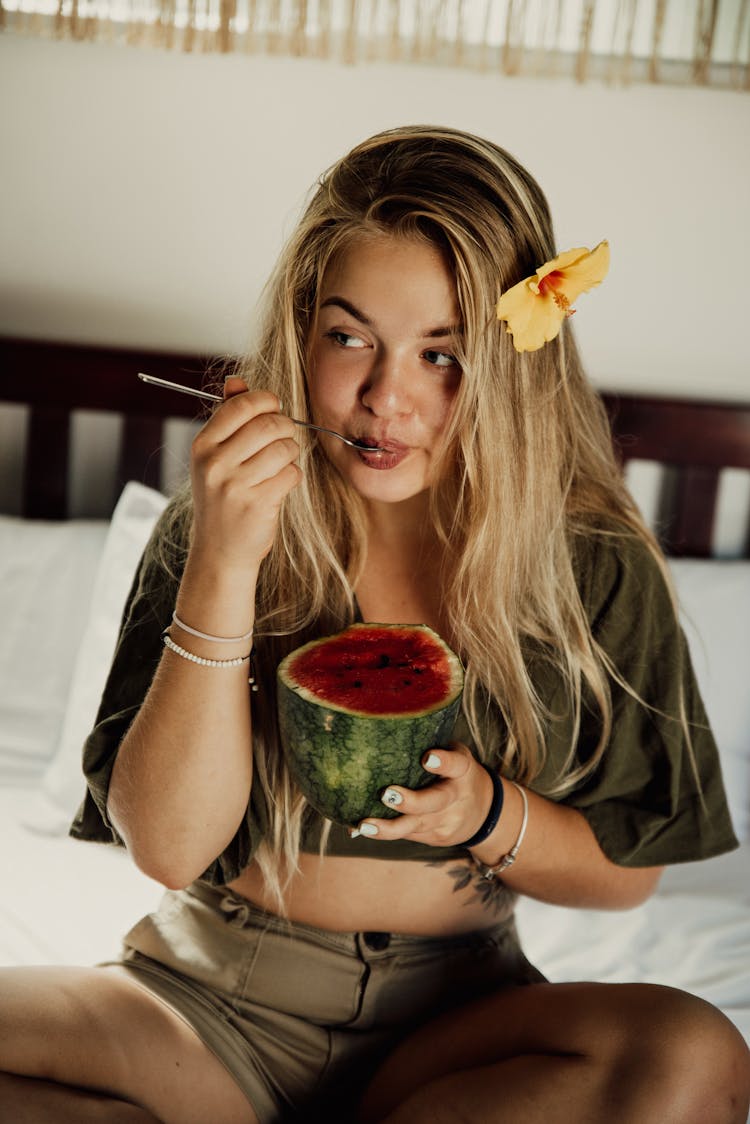 A Woman Eating A Watermelon