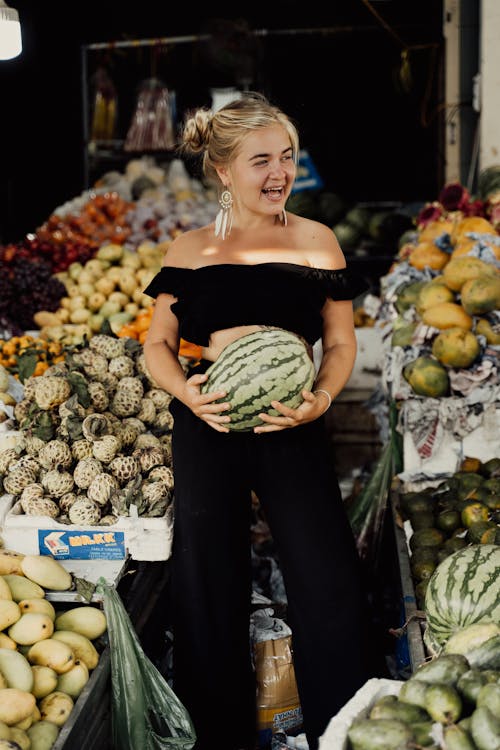 A Woman in an Off-Shoulder Crop Top Holding a Watermelon