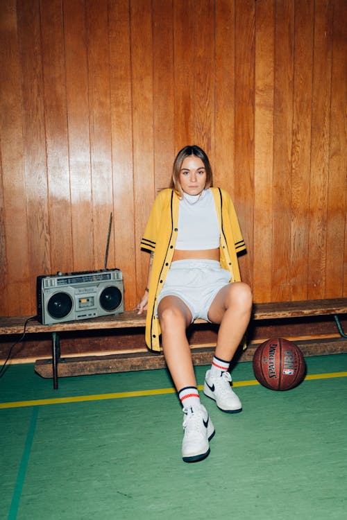 A Woman Sitting beside a Cassette Player