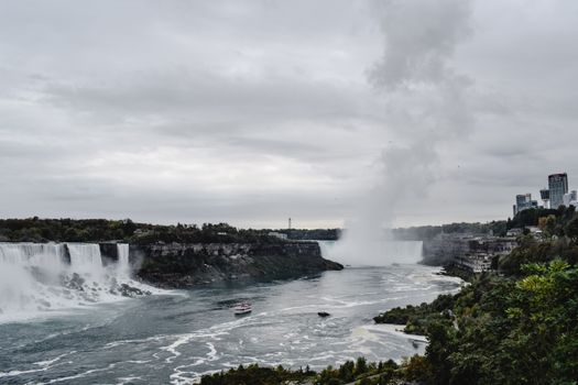 Capture of Niagara Falls showcasing its powerful flow under a cloudy sky, reflecting natural beauty.