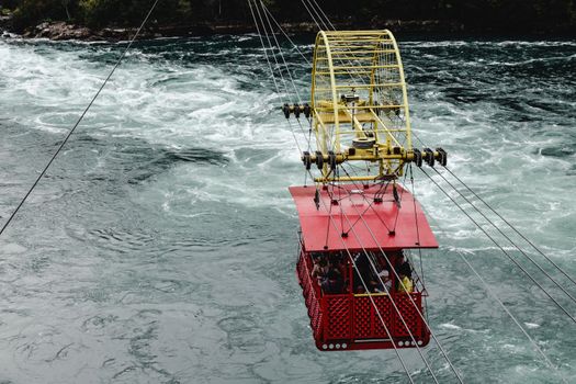 Whirlpool Aero Car traversing the swirling waters of the Niagara River gorge. Ideal for travel and adventure themes.