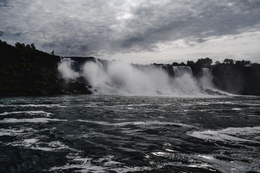 Stunning capture of Niagara Falls with a dramatic sky, showcasing natural wonder.